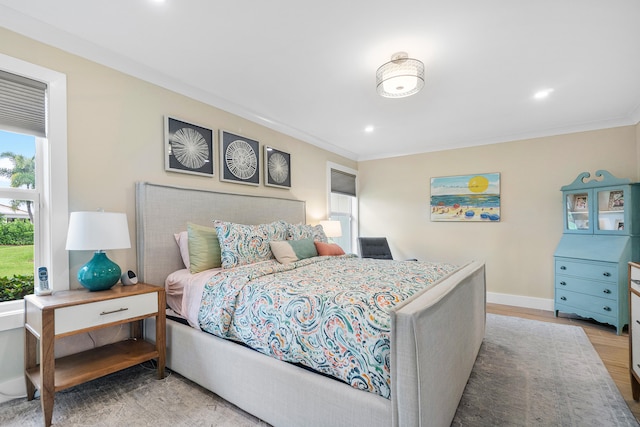 bedroom featuring crown molding and hardwood / wood-style flooring