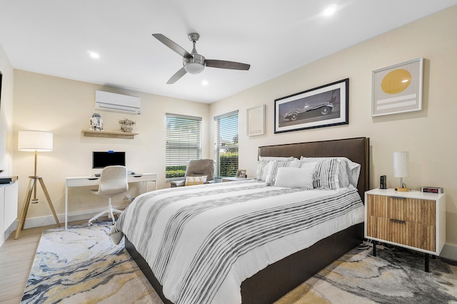 bedroom featuring light hardwood / wood-style flooring, an AC wall unit, and ceiling fan