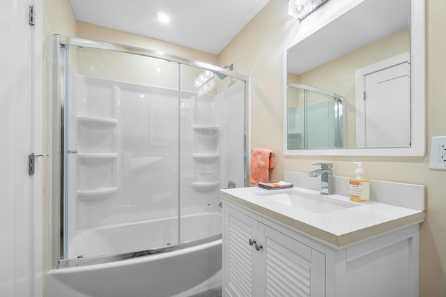 bathroom with vanity and shower / bath combination with glass door