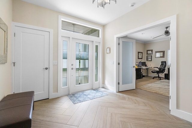 foyer entrance with light parquet flooring and ceiling fan