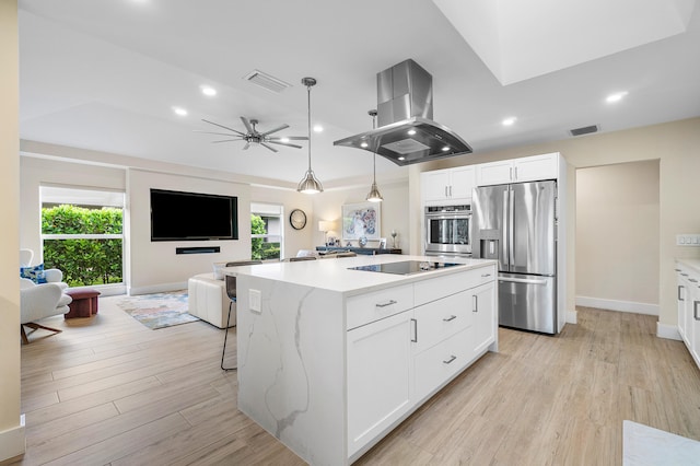 kitchen featuring white cabinets, stainless steel appliances, island range hood, and a kitchen island