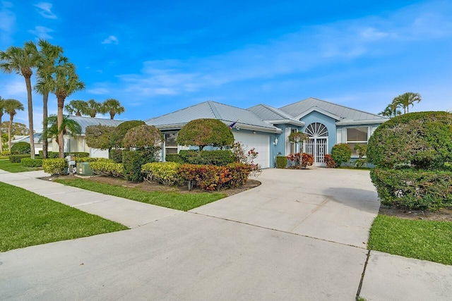 ranch-style home with a front yard and a garage