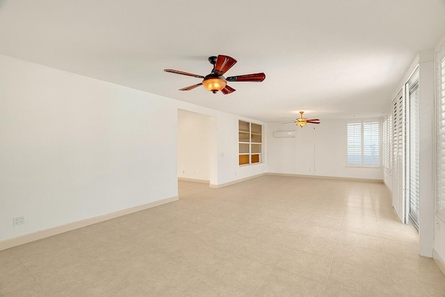 empty room featuring a wall mounted air conditioner and ceiling fan