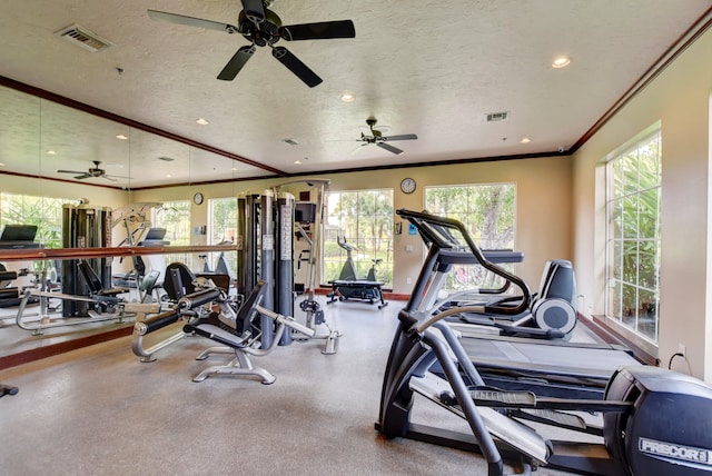 gym featuring ornamental molding, a textured ceiling, and ceiling fan