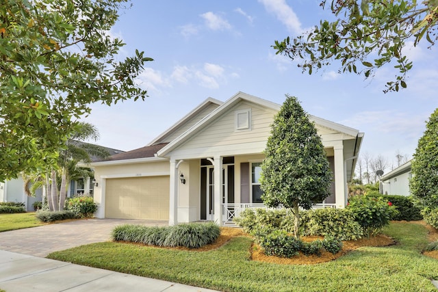 view of front facade with a front yard and a garage