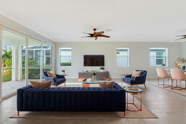 living room with light tile patterned floors, ceiling fan, and ornamental molding