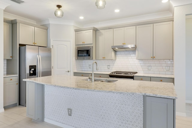 kitchen with light stone countertops, sink, crown molding, decorative backsplash, and appliances with stainless steel finishes