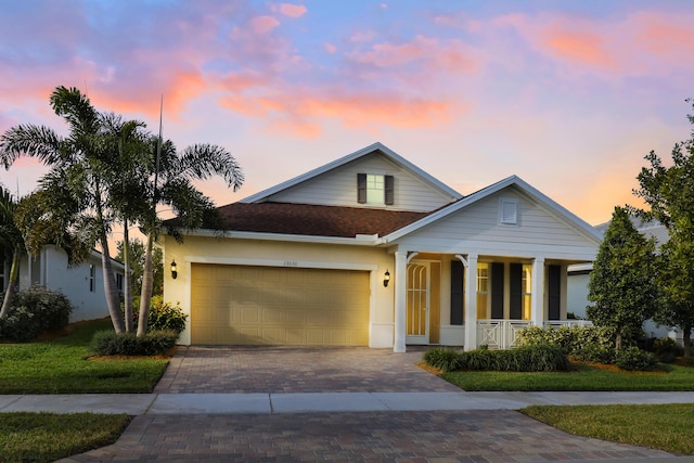 view of front of home featuring covered porch and a garage