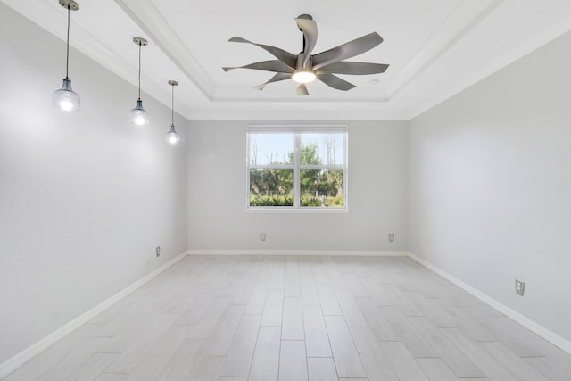 unfurnished room featuring ornamental molding, a tray ceiling, ceiling fan, and light hardwood / wood-style floors