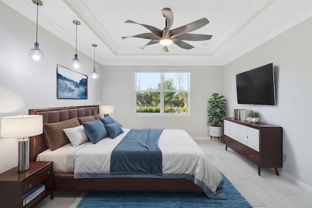 bedroom with a tray ceiling, ceiling fan, and crown molding