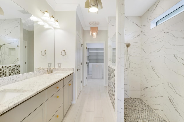 bathroom with vanity and tiled shower