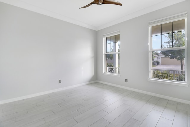 unfurnished room with ceiling fan and crown molding