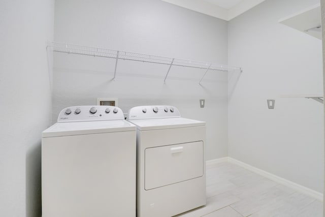 washroom with washing machine and clothes dryer