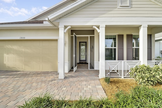 property entrance featuring a porch and a garage