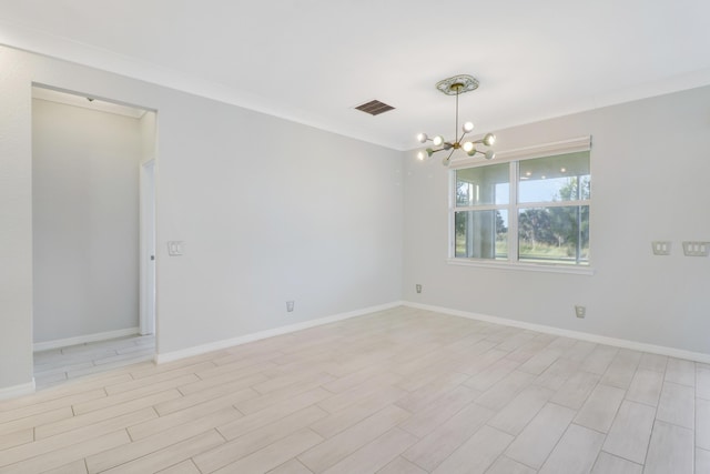 empty room featuring light hardwood / wood-style floors, an inviting chandelier, and crown molding