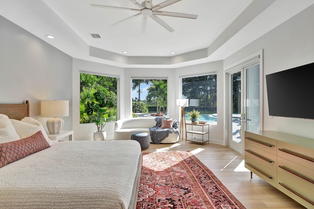 bedroom featuring ceiling fan, access to outside, and light hardwood / wood-style flooring