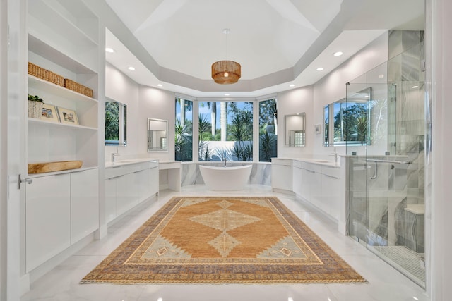 bathroom with vanity, shower with separate bathtub, and a tray ceiling