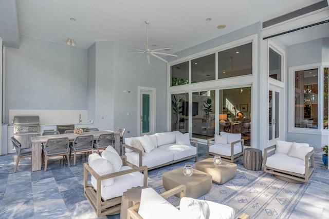 view of patio with area for grilling, ceiling fan, grilling area, and an outdoor hangout area