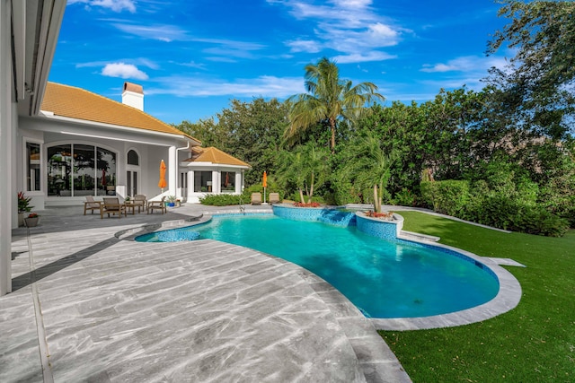 view of swimming pool featuring a yard and a patio area