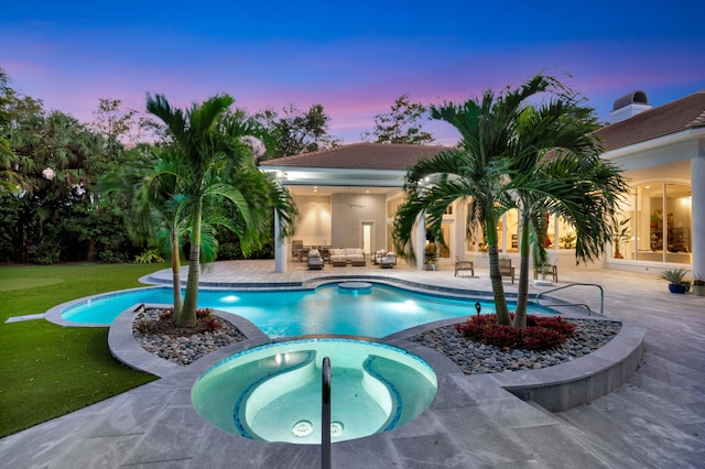 pool at dusk with a patio area, french doors, an in ground hot tub, and a lawn