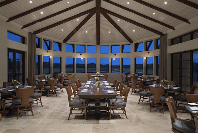 dining area with wood ceiling, beam ceiling, and high vaulted ceiling