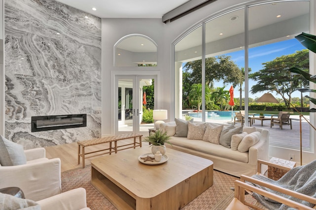 living room featuring a premium fireplace and french doors