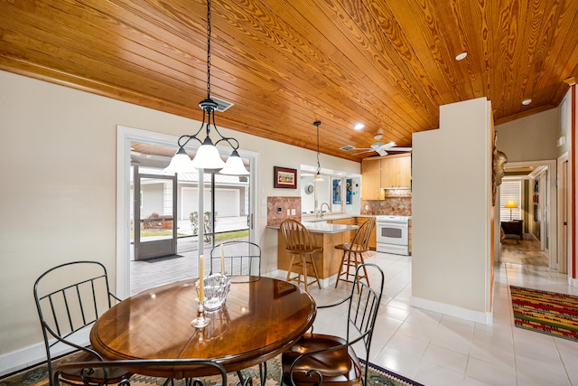 tiled dining space featuring crown molding, wooden ceiling, sink, and vaulted ceiling