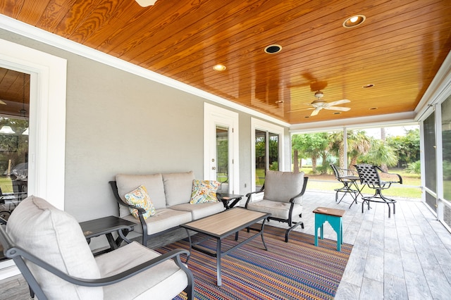 sunroom with wood ceiling and ceiling fan