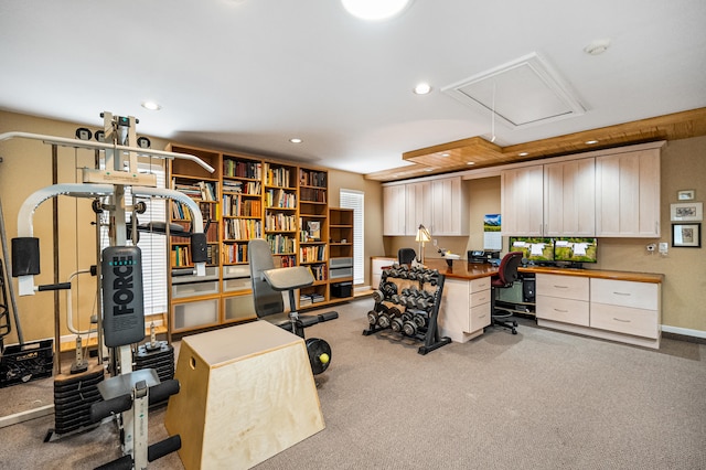 carpeted office featuring built in desk