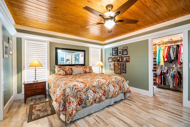 bedroom with wood ceiling, a closet, ceiling fan, crown molding, and light hardwood / wood-style flooring