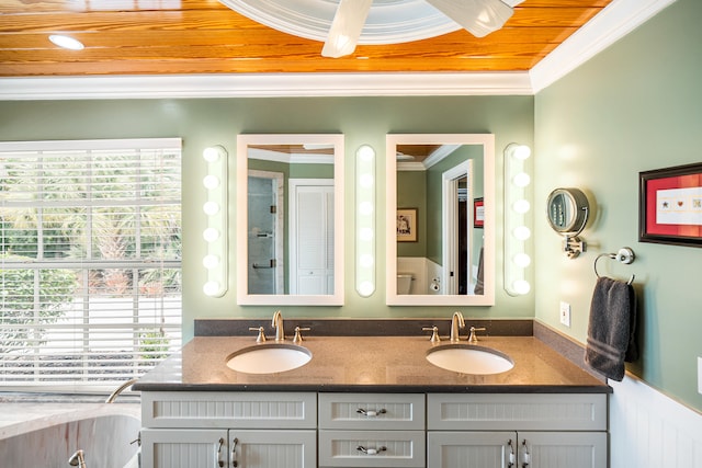 bathroom featuring vanity, crown molding, and a healthy amount of sunlight