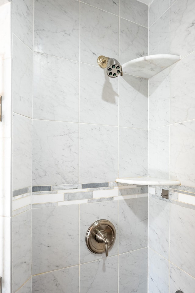 bathroom with a tile shower