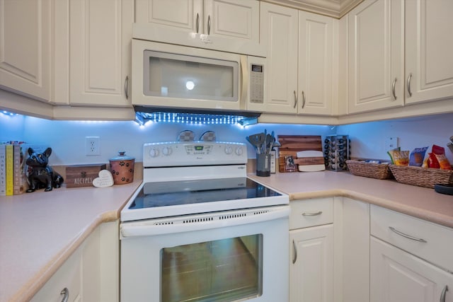 kitchen with white appliances and white cabinets