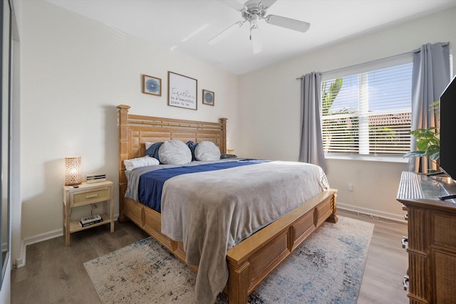 bedroom with ceiling fan and hardwood / wood-style floors