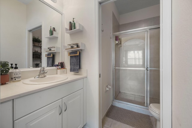 bathroom featuring vanity, toilet, tile patterned flooring, and a shower with door