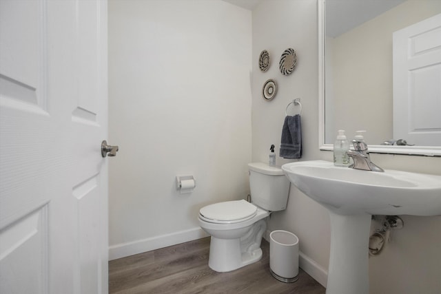 bathroom featuring toilet and hardwood / wood-style flooring