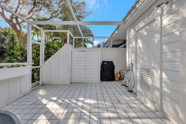 view of patio / terrace with a lanai