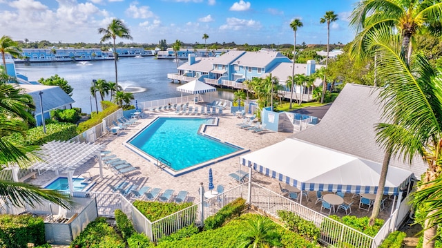 view of pool with a patio and a water view