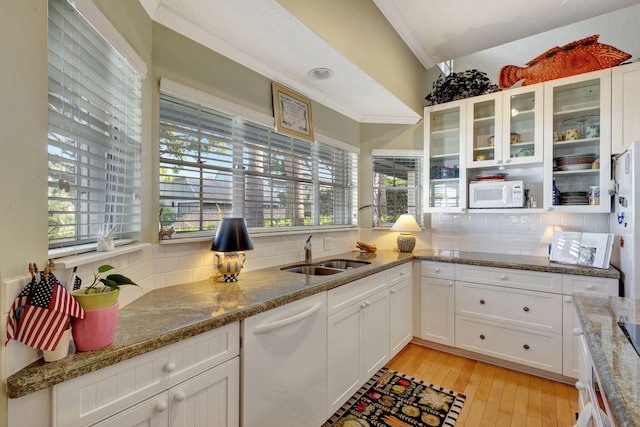 kitchen with white appliances, white cabinetry, light hardwood / wood-style flooring, and plenty of natural light