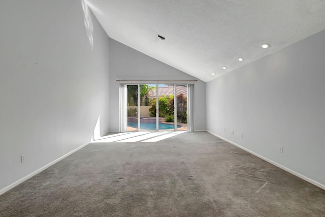 unfurnished living room with high vaulted ceiling and carpet floors