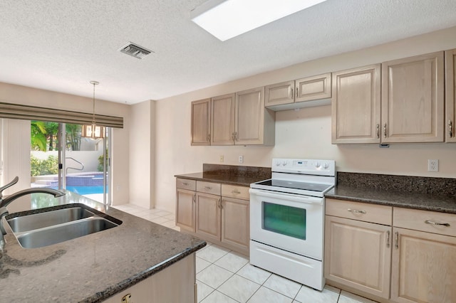 kitchen featuring sink, white range with electric stovetop, light brown cabinets, light tile patterned floors, and decorative light fixtures