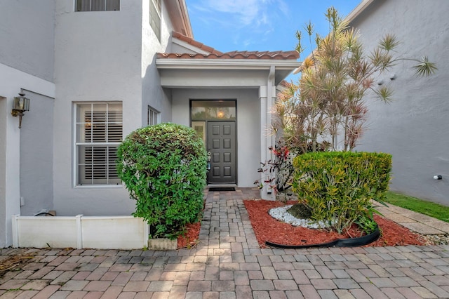 property entrance featuring a patio area