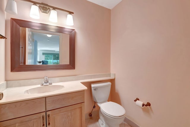 bathroom featuring tile patterned flooring, vanity, and toilet