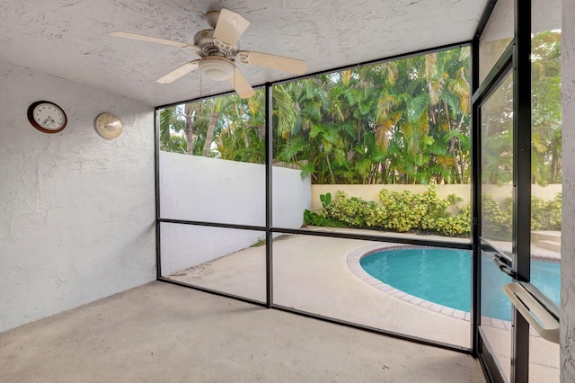 view of swimming pool featuring ceiling fan and a patio area