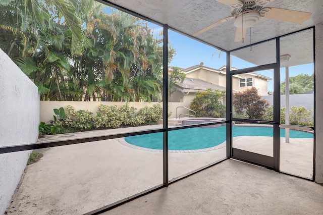 view of swimming pool featuring ceiling fan and a patio