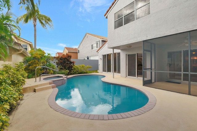 view of swimming pool with an in ground hot tub and a patio area