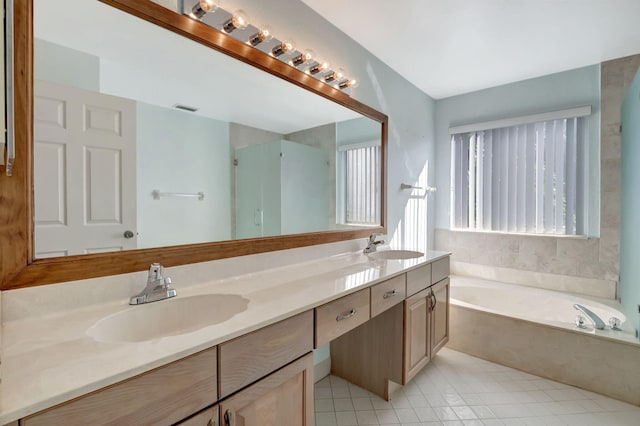 bathroom featuring shower with separate bathtub, vanity, and tile patterned floors