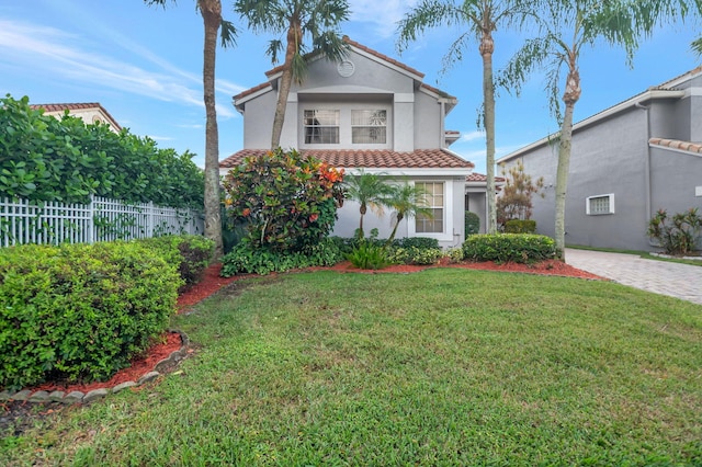 mediterranean / spanish house with a front lawn