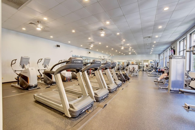 gym with a paneled ceiling