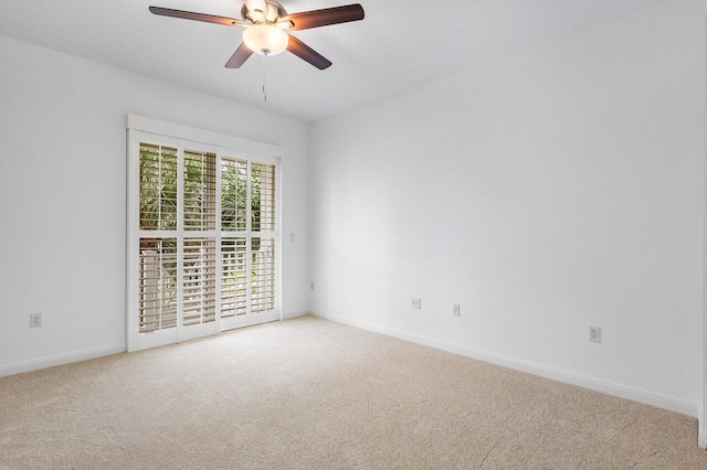 carpeted spare room with ceiling fan